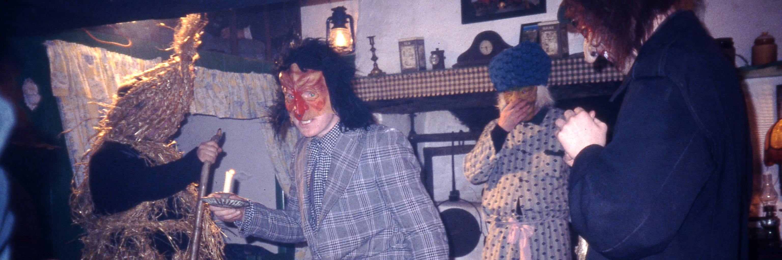 People dressed in costumes, dancing around a room.